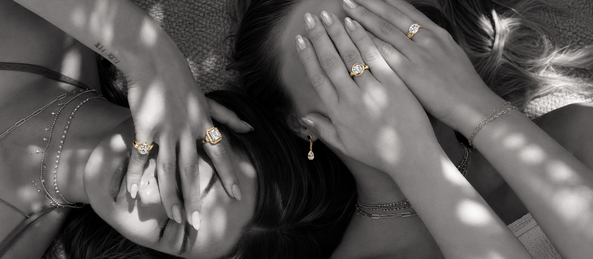 Woman wearing a PURE ID gold diamond ring while framing her eye with her hand